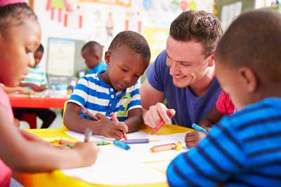 male teacher with young students